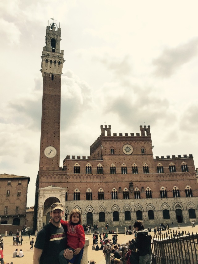 Jon and Lilybelle pose in front of the Palazzo Pubblico and the Torre del Mangia